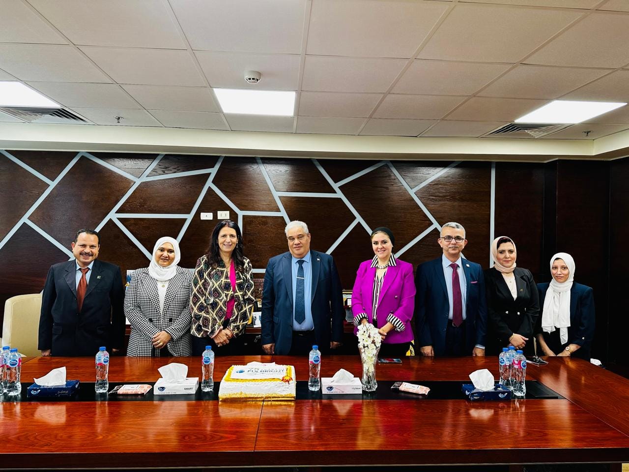 Award ceremony honoring university students with certificates and trophies